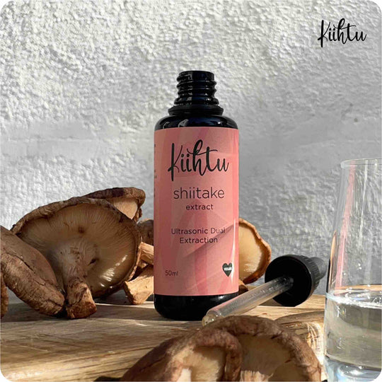 Kiihtu Shiitake Mushroom Extract Tincture - Bottle placed next to Shiitake Mushrooms and shown simply being added to a glass of water