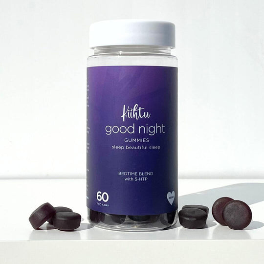 A bottle of Good night gummies by Kiihtu, which are sleep gummy to help support a deep longer sleep.  There are several sleep gummies scattered around the bottle, showing you a tasty way to take a bedtime blend of gummies before bed time.